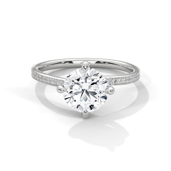 “Celeste Ring—round brilliant diamond beauty, four-prong tulip elegance, and refined pavé sparkle crafted to symbolize timeless love, radiant grace, and everlasting sophistication.”