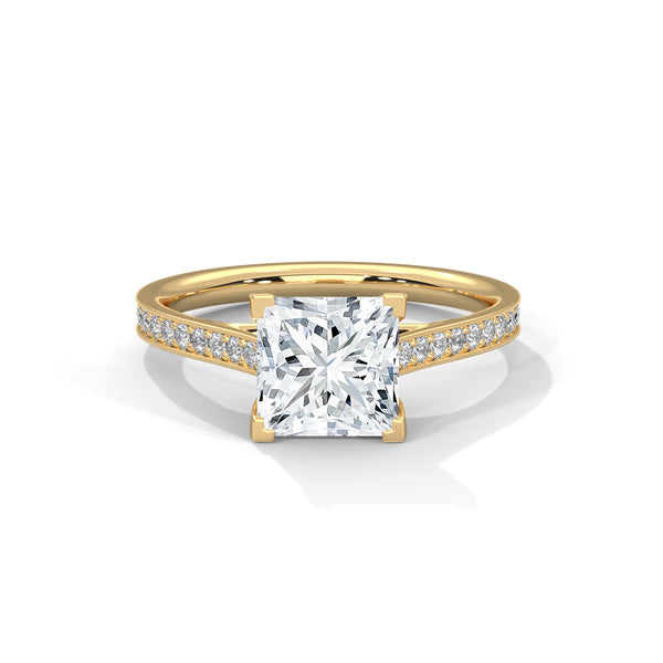 “Aria Ring—princess-cut diamond brilliance, sleek four-prong elegance, and pavé-band sparkle crafted to symbolize modern beauty, timeless love, and unforgettable moments.”