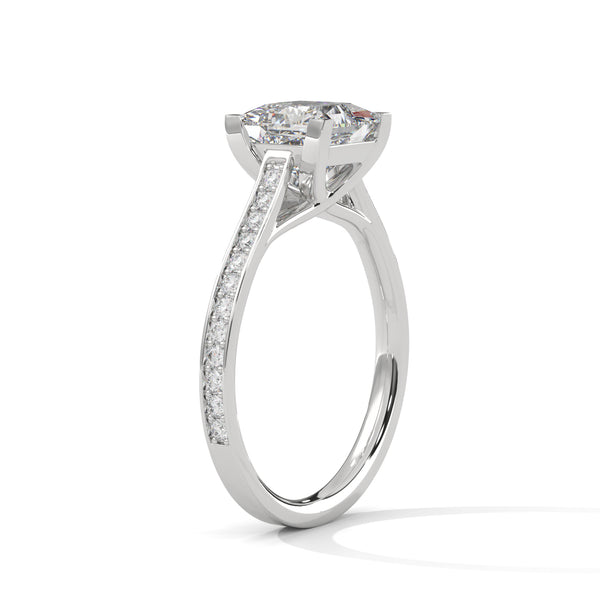 “Aria Ring—princess-cut diamond brilliance, sleek four-prong elegance, and pavé-band sparkle crafted to symbolize modern beauty, timeless love, and unforgettable moments.”