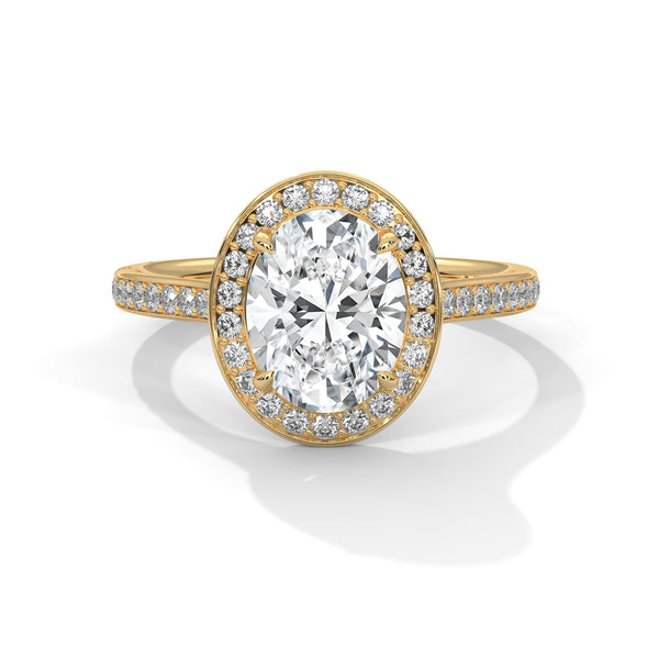 “Oval diamond halo ring in yellow gold—brilliantsparkle, pavé band elegance, and timeless luxurycrafted for unforgettable love and lifetimebeauty.”