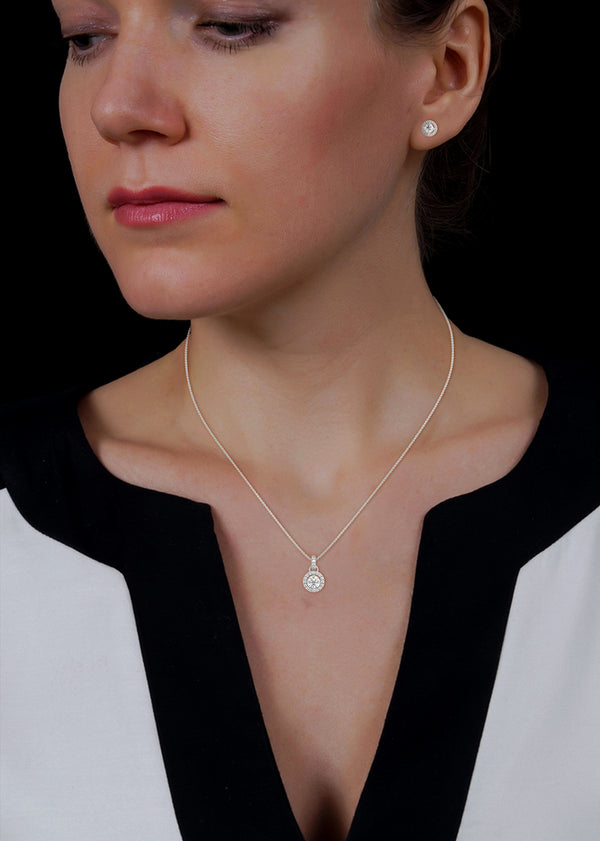 A dazzling rose gold pendant and earring set with shimmering round-cut diamonds encircled by a radiant halo, capturing elegance in every sparkle.