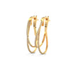 Stylishly layered gold hoops, adorned with sparkling diamonds for a bold yet elegant statement.
