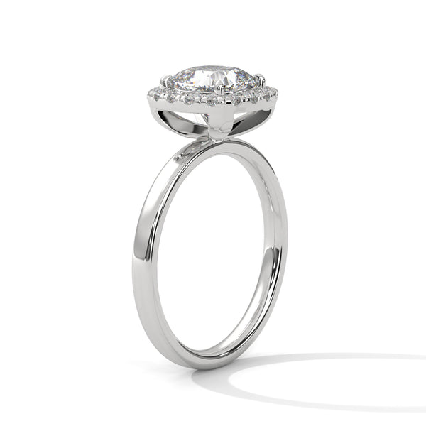A soft cushion-shaped halo embraces a brilliant round lab-grown diamond — a romantic take on radiant sparkle.