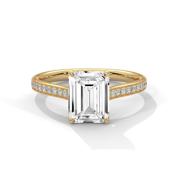 The Celestial Elegance Ring features a striking emerald-cut diamond embraced by a delicate band adorned with shimmering pave stones. A timeless piece that symbolizes everlasting love and sophistication.