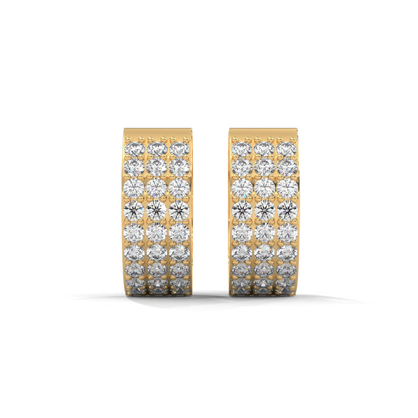 Elegant yellow gold huggie earrings adorned with three radiant rows of dazzling diamonds.