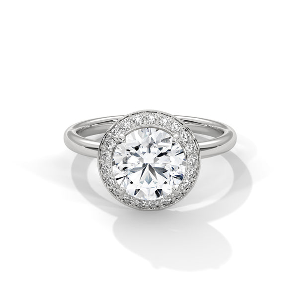 “Celestial Halo Ring—round-cut brilliance, radiant halo sparkle, and white-gold elegance crafted to symbolize everlasting love, timeless beauty, and unforgettable engagements.”