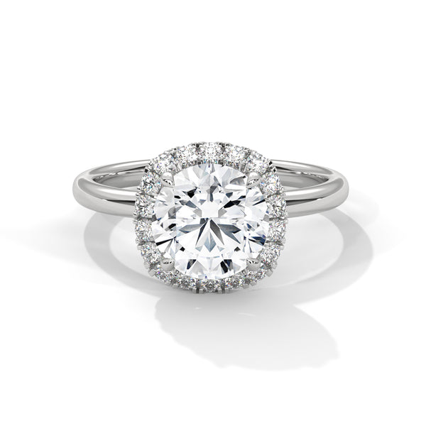 “Aurielle Ring—round-diamond brilliance, cushion-halo elegance, and sleek white-gold luxury crafted to symbolize timeless love, modern charm, and unforgettable moments.”