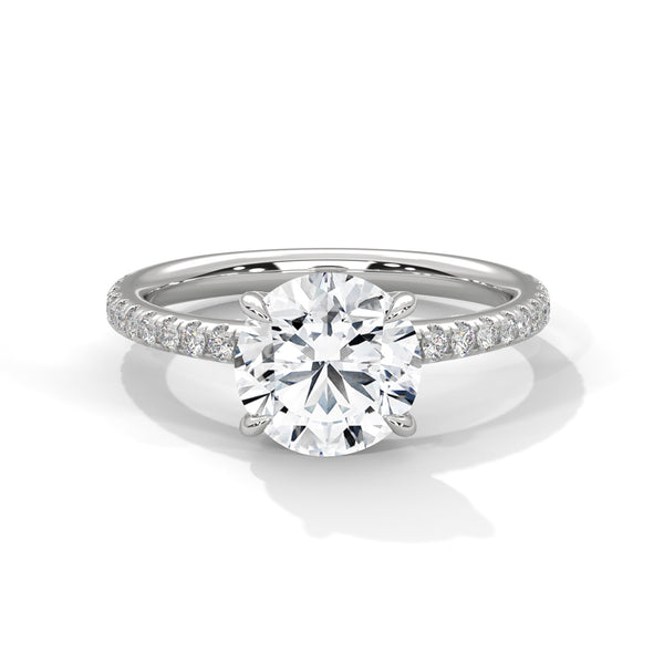 “Celeste Ring—round-cut diamond brilliance, delicate pavé sparkle, and classic white-gold elegance crafted to symbolize timeless beauty, modern romance, and unforgettable moments.”