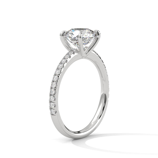 “Celeste Ring—round-cut diamond brilliance, delicate pavé sparkle, and classic white-gold elegance crafted to symbolize timeless beauty, modern romance, and unforgettable moments.”