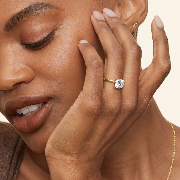 A sleek and modern solitaire ring featuring a round brilliant diamond in a classic four-prong setting atop a refined white gold band.