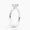 A sleek and modern solitaire ring featuring a round brilliant diamond in a classic four-prong setting atop a refined white gold band.