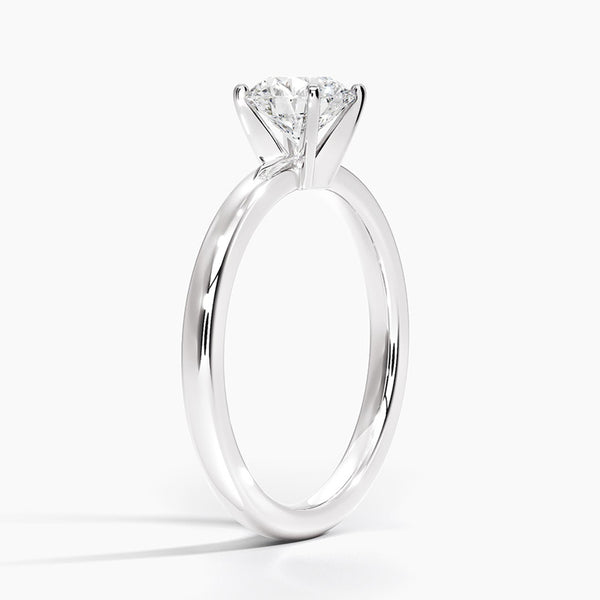 A sleek and modern solitaire ring featuring a round brilliant diamond in a classic four-prong setting atop a refined white gold band.