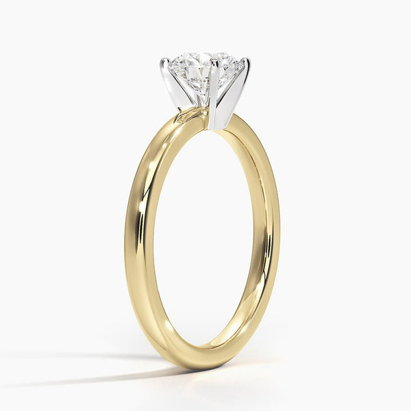 A sleek and modern solitaire ring featuring a round brilliant diamond in a classic four-prong setting atop a refined white gold band.
