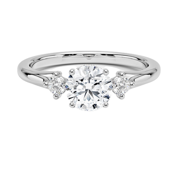 A symbol of harmony and devotion, the Lunara Grace features a round brilliant center flanked by perfectly matched side stones on a gracefully tapered band.