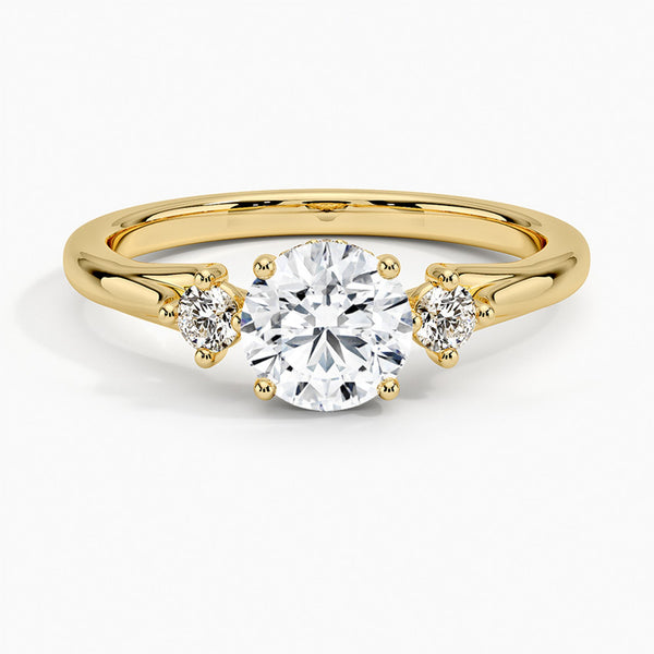 A symbol of harmony and devotion, the Lunara Grace features a round brilliant center flanked by perfectly matched side stones on a gracefully tapered band.