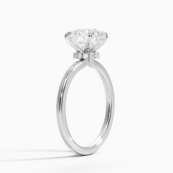 A round brilliant solitaire embraced by an intricate vine-inspired setting, intertwining elegance and organic artistry.