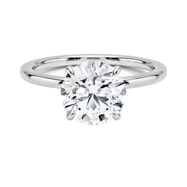 A round brilliant solitaire embraced by an intricate vine-inspired setting, intertwining elegance and organic artistry.