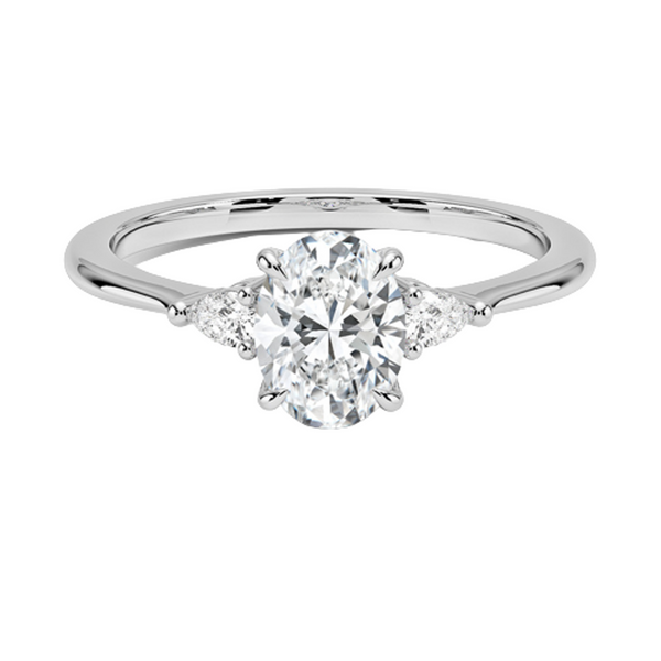 An elegant three-stone ring featuring a radiant oval center gem embraced by soft pear-cut side stones.