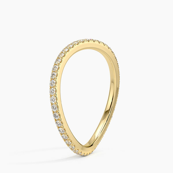 “Elegant curved diamond band crafted in luxurious yellow gold, offering a perfect stackable wedding ring with timeless sparkle and modern sophistication.”