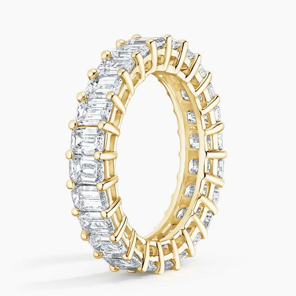 “Luxurious emerald-cut diamond eternity band in radiant yellow gold, delivering bold brilliance, timeless elegance, and unmatched sparkle for unforgettable everyday sophistication.”