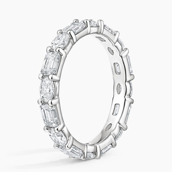 "Luxurious oval and emerald-cut diamond eternity ring crafted in radiant white gold, delivering timeless brilliance, elite craftsmanship, and unmatched elegance."