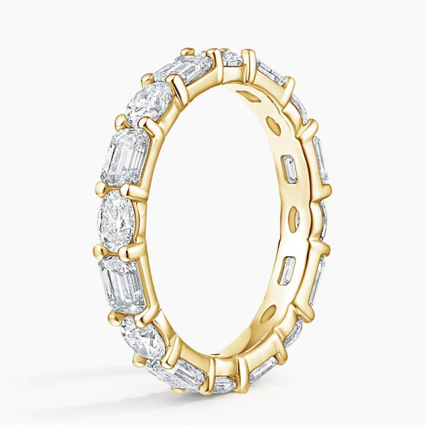 "Luxurious oval and emerald-cut diamond eternity ring crafted in radiant white gold, delivering timeless brilliance, elite craftsmanship, and unmatched elegance."