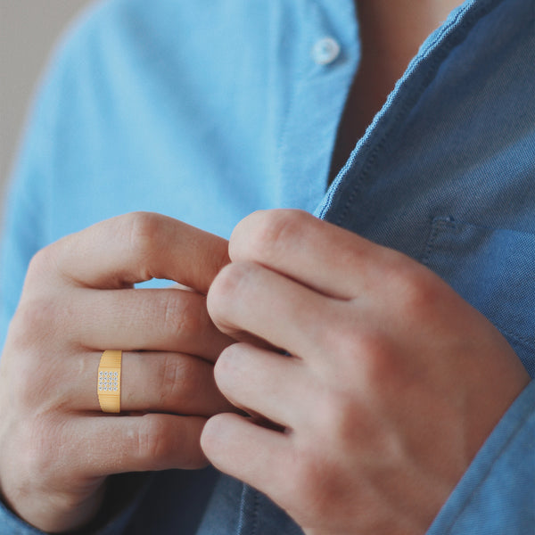 “Bold gold men’s diamond ring showcasing a sleek grooved band and radiant square diamond cluster, crafted for luxury, style, and everyday elegance.”