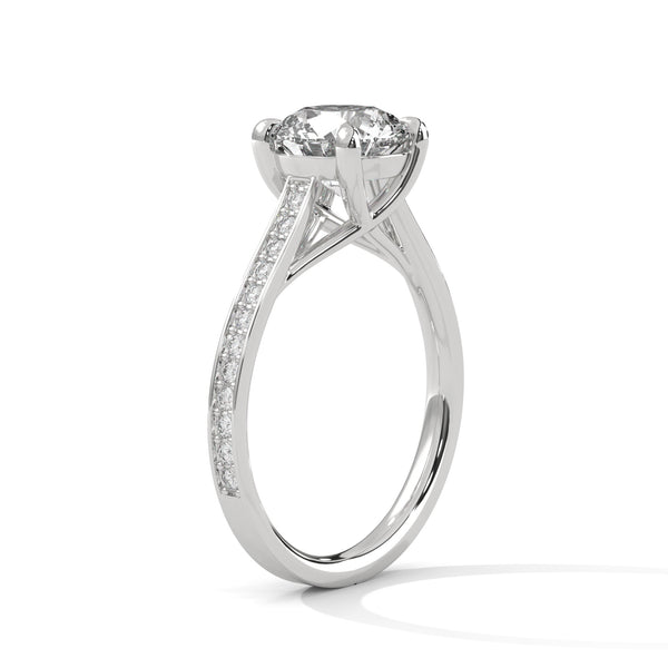 “Aurora Ring—round brilliant diamond sparkle, sleek pavé-band elegance, and timeless white-gold beauty crafted to symbolize radiant love, grace, and unforgettable moments.”