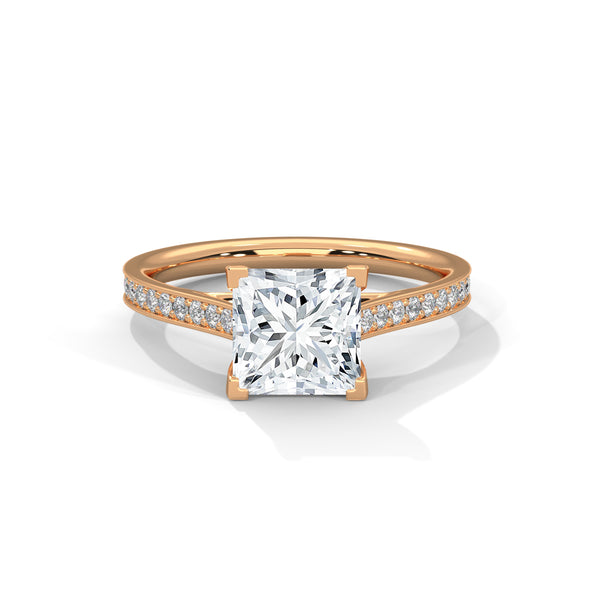 “Aria Ring—princess-cut diamond brilliance, sleek four-prong elegance, and pavé-band sparkle crafted to symbolize modern beauty, timeless love, and unforgettable moments.”