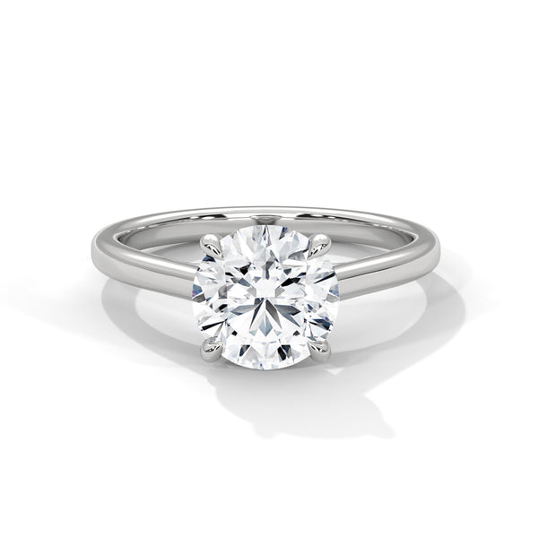 “Celeste Ring—round brilliant diamond sparkle, minimalist four-prong solitaire elegance, and timeless white-gold beauty crafted to symbolize pure love and lasting sophistication.”
