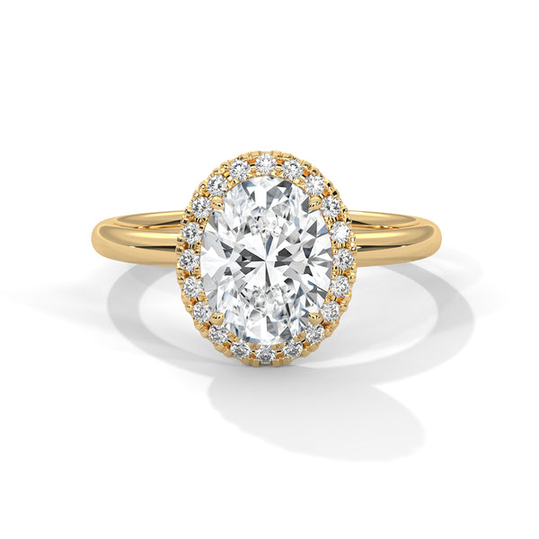A graceful oval-cut lab-grown diamond encircled by a shimmering halo — effortless elegance with eye-catching brilliance