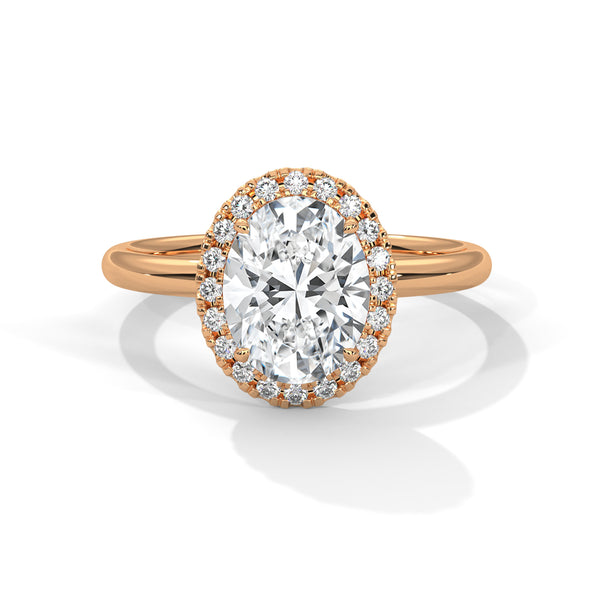A graceful oval-cut lab-grown diamond encircled by a shimmering halo — effortless elegance with eye-catching brilliance
