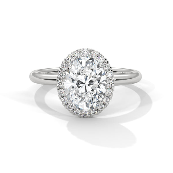 A graceful oval-cut lab-grown diamond encircled by a shimmering halo — effortless elegance with eye-catching brilliance