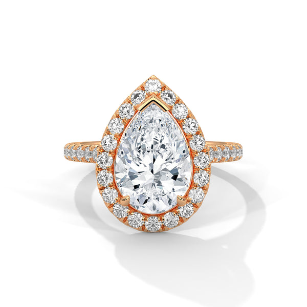 “Pear-shaped diamond halo ring in rosegold—radiant brilliance, pavé-band sparkle, andluxurious elegance crafted for timeless love andunforgettable moments.”