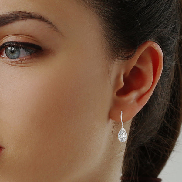 Dramatic rose gold danglers with pear-shaped centerpieces and a cascade of diamonds for breathtaking brilliance.