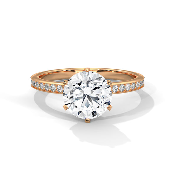 “Radiate brilliance with this rose gold round-cut diamond ring, featuring pavé detailing and timeless elegance for the perfect engagement statement.”