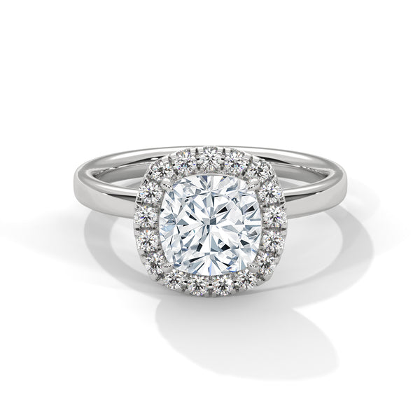 A soft cushion-shaped halo embraces a brilliant round lab-grown diamond — a romantic take on radiant sparkle.