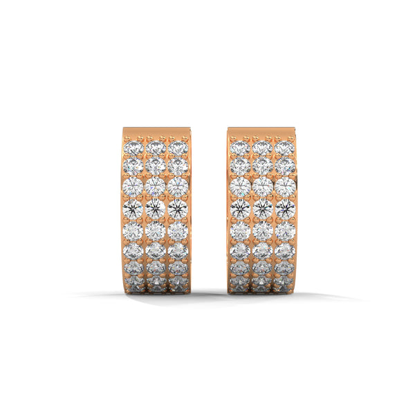 Elegant yellow gold huggie earrings adorned with three radiant rows of dazzling diamonds.