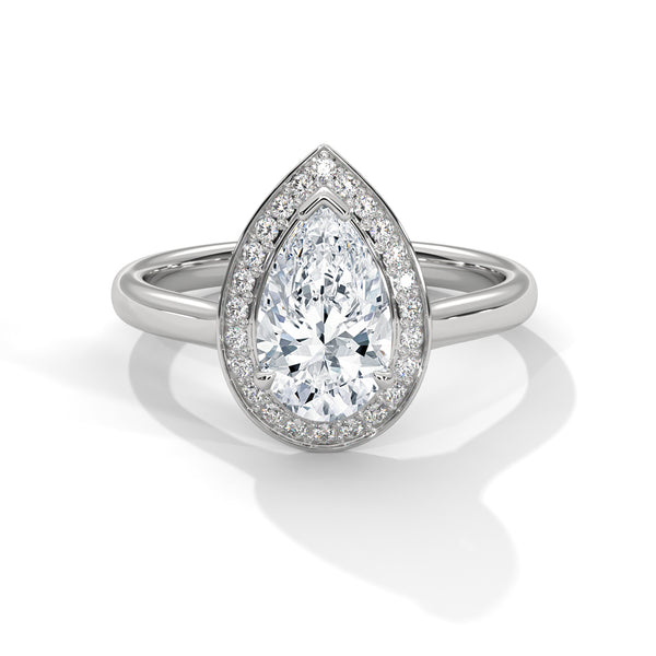“Celeste Ring—pear-shaped diamond brilliance, radiant halo sparkle, and modern white-gold elegance crafted to symbolize celestial beauty, timeless love, and unforgettable moments.”
