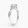 A round brilliant solitaire embraced by an intricate vine-inspired setting, intertwining elegance and organic artistry.