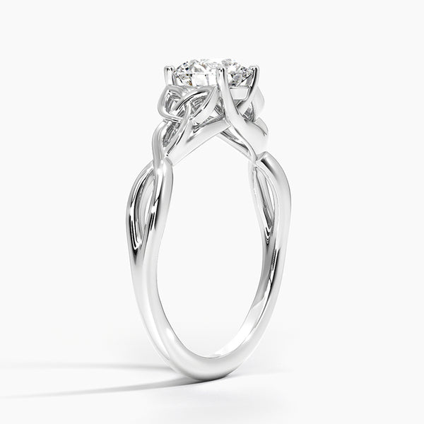 A round brilliant solitaire embraced by an intricate vine-inspired setting, intertwining elegance and organic artistry.