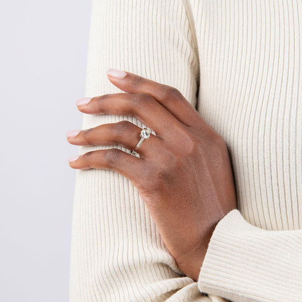 Astrielle Grace radiates refined simplicity with its elegant cathedral setting and softly tapered band, offering a timeless frame for its center diamond.