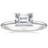 Solstice Grace is a minimalist masterpiece, showcasing an emerald-cut diamond in a classic four-prong setting with a smooth, polished band that radiates refined simplicity.