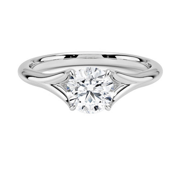 A modern solitaire with sculptural grace, the Seraphine Crest features elegantly arched prongs lifting a brilliant round diamond in a soft, sweeping embrace.