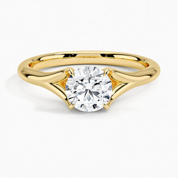 A modern solitaire with sculptural grace, the Seraphine Crest features elegantly arched prongs lifting a brilliant round diamond in a soft, sweeping embrace.