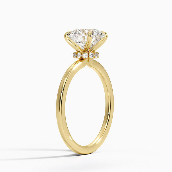 A round brilliant solitaire embraced by an intricate vine-inspired setting, intertwining elegance and organic artistry.