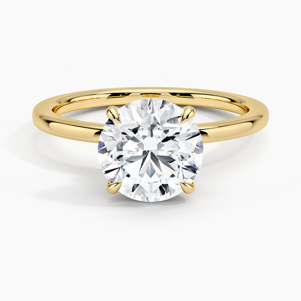 A round brilliant solitaire embraced by an intricate vine-inspired setting, intertwining elegance and organic artistry.