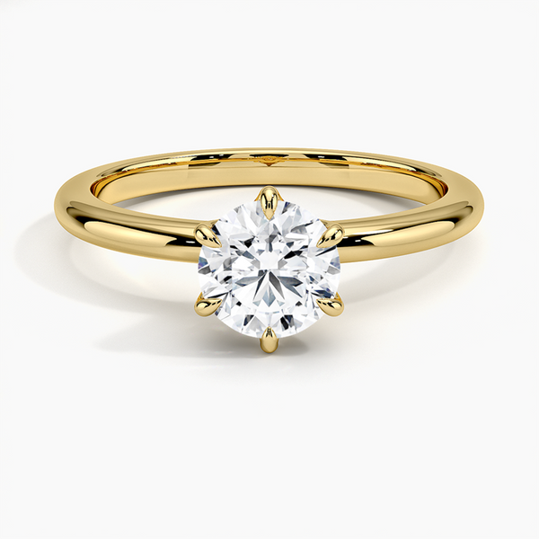 A refined solitaire ring featuring a round brilliant diamond held in a six-prong trellis setting, paired with a polished white gold band.