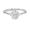 An elegant three-stone ring featuring a radiant oval center gem embraced by soft pear-cut side stones.