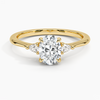 An elegant three-stone ring featuring a radiant oval center gem embraced by soft pear-cut side stones.